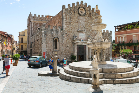 TAORMINA, ITALY - JUNE 29, 2017: tourists on Piazza dell Duomo near fountain in Taormina city. Taormina is resort town on Ionian Sea in Sicilyのeditorial素材