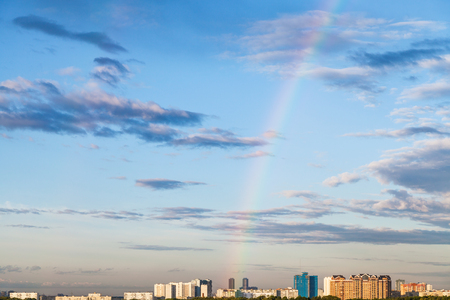 rainbow in blue evening sky over residential district in Moscow city in summerの写真素材