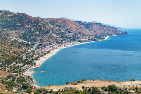 travel to Sicily, Italy - above view of Letojanni resort town of beach of Ionian Sea from Taormina city in summer dayの写真素材