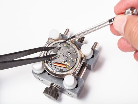 watchmaker workshop - replacement battery in quartz watch close up on white backgroundの写真素材