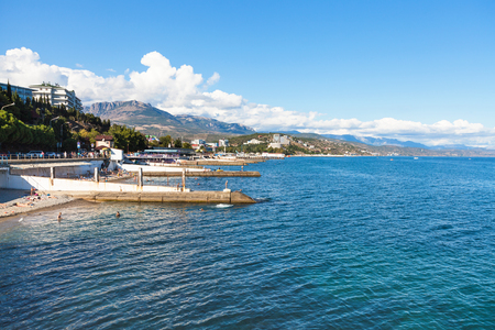 ALUSHTA, CRIMEA - SEPTEMBER 24, 2017: view of tourists and urban beach along embankment in professors corner in Alushta city. Alushta is seaside resort town on southern coast of the Crimeaのeditorial素材
