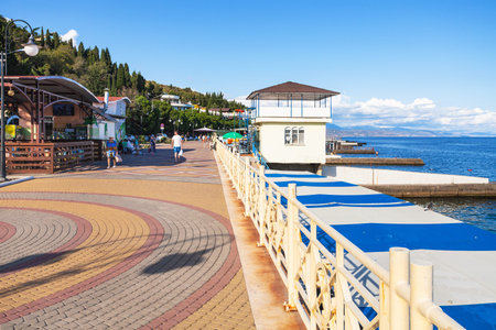 ALUSHTA, CRIMEA - SEPTEMBER 24, 2017: tourists walk on embankment in professors corner district in Alushta city on coast of Black Sea. Alushta is seaside resort town on southern coast of the Crimeaのeditorial素材