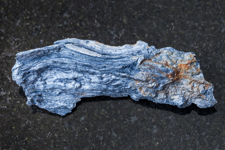 macro shooting of natural mineral rock specimen - rough Rhodusite stone on dark granite background from Kazakhstanの写真素材