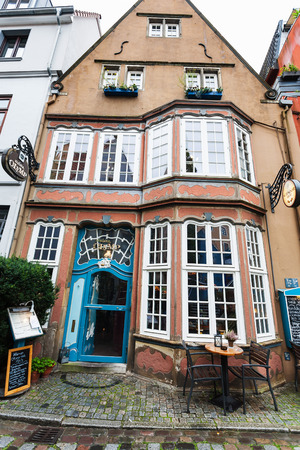 BREMEN, GERMANY - SEPTEMBER 16, 2017: front view of old restaurant in Schnoor quarter in rain. Schnoor is a district in the medieval centre of Bremen cityのeditorial素材