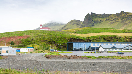 VIK I MYRDAL, ICELAND - SEPTEMBER 9, 2017: hotels area and Reyniskirkja church on hill in Vik I Myrdal village on Atlantic South Coast in Katla Geopark in september.のeditorial素材