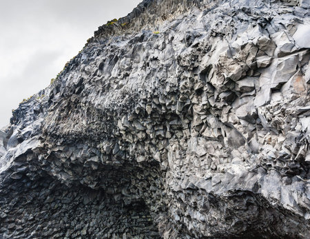 travel to Iceland - volcanic walls of Reynisfjall mount over Halsanefshellir cave on Reynisfjara beach in Iceland, near Vik I Myrdal village on Atlantic South Coast in Katla Geopark in septemberの写真素材
