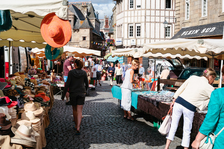 PAIMPOL, FRANCE - JULY 6, 2010: people on outdoor flea market on Place du Martray in Paimpol city. Paimpol is a commune in the Cotes-d'Armor department in Brittany on coast of English Channel.のeditorial素材