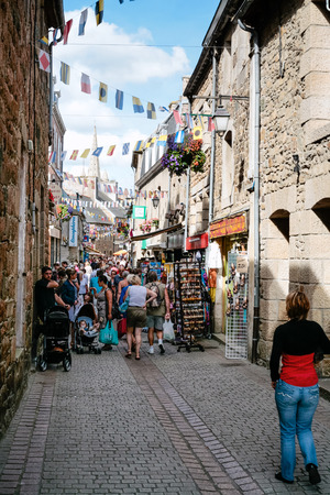 PAIMPOL, FRANCE - JULY 6, 2010: people on shopping street Rue de L'Eglise in Paimpol city in summer. Paimpol is a commune in the Cotes-d'Armor department in Brittany on coast of English Channel.のeditorial素材