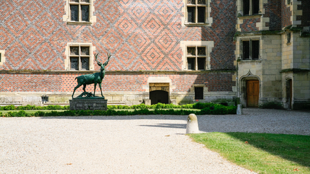 GIEN, FRANCE - JULY 9, 2010: deer statue in court of castle near museum in Chateau de Gien. Chateau was built in the XVth century for Anne of Franc, it was bombed in 1940 and later restoredのeditorial素材