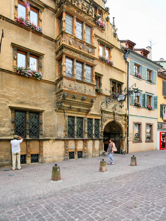 COLMAR, FRANCE - JULY 11, 2010: tourist near house Maison des Tetes (House of Heads) on Rue des Tetes in Colmar.This house was built in 1609 by architect Hans Burgeのeditorial素材