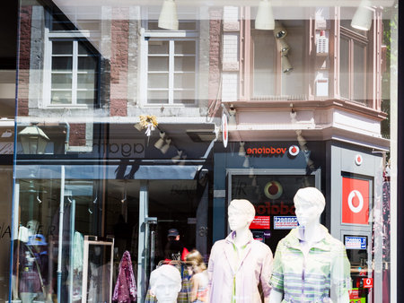AACHEN, GERMANY - JUNE 27, 2010: reflection in the shop window on Kramerstrasse street in Aachen in...