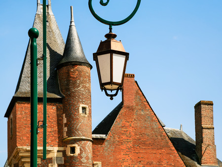 GIEN, FRANCE - JULY 9, 2010: outdoor lantern and towers of castle Chateau de Gien. Chateau was built in the XVth century for Anne of Franc, it was bombed in 1940 and later restoredのeditorial素材