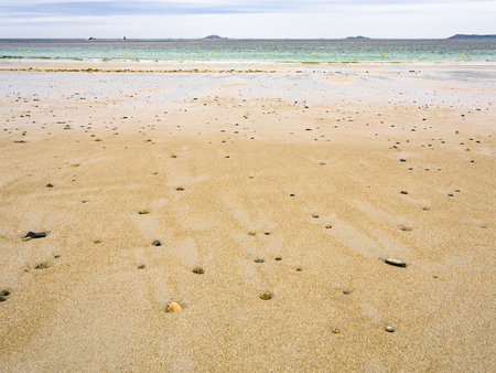 travel to France- surface of sand beach Plage de Trestrignel in Perros-Guirec town in the Cotes-d'Armor department in Brittany in rainy summer dayの写真素材