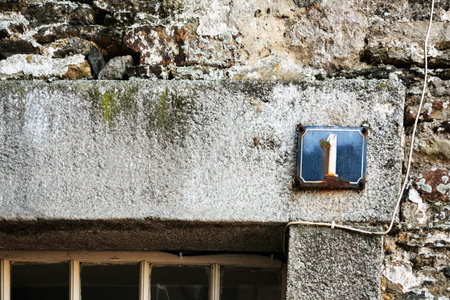 travel to France - shabby number plate 1 on wall of medieval house in Vitre town in Ille-et-Vilaine department of Brittany in sunny summer dayの写真素材