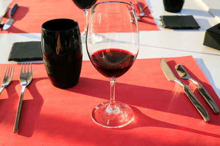 travel to France - wineglass with local red wine from Val de Loire region on table in outdoor restaurant in Orleans city in summer eveningの写真素材