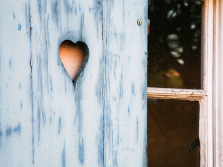 Travel to France - heart shaped pattern carved in outdoor wooden shutter in old house in Petite France quarter of Strasbourg cityの写真素材