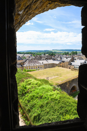 SEDAN, FRANCE - JUNE 30, 2010: view of urban houses through embrasure of castle Chateau de Sedan in summer day. Sedan is a commune in Ardennes department, the castle began to be built in 1424のeditorial素材