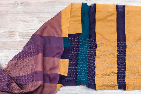 workshop on sewing a patchwork scarf - raw stitched silk shawl on table