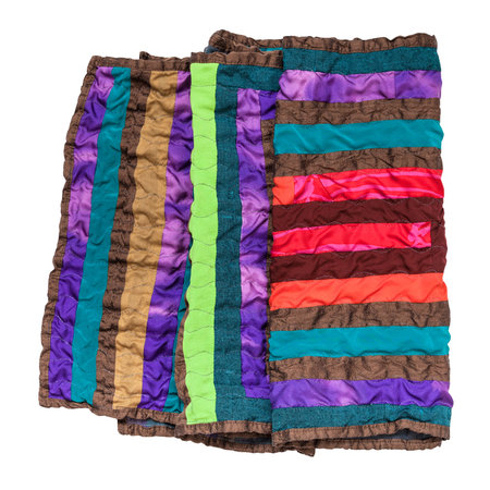 folded stitched patchwork scarf from silk strips isolated on white background