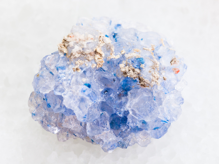 macro shooting of natural mineral rock specimen - rough celestine stone on white marble backgroundの写真素材