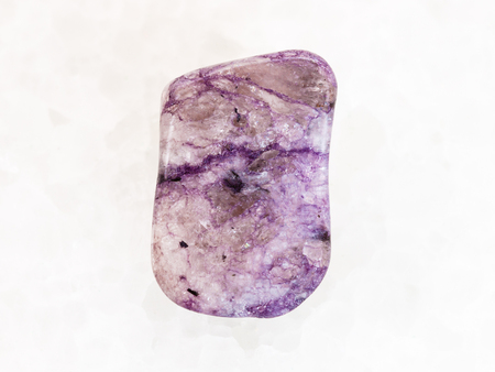 macro shooting of natural mineral rock specimen - polished Amethyst gemstone on white marble background from Brazilの写真素材