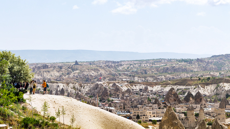 GOREME, TURKEY - MAY 6, 2018: tourists on viewpoint over Goreme town. Goreme is town in Cappadocia, in the Nevsehir Province in Central Anatolia of Turkeyのeditorial素材