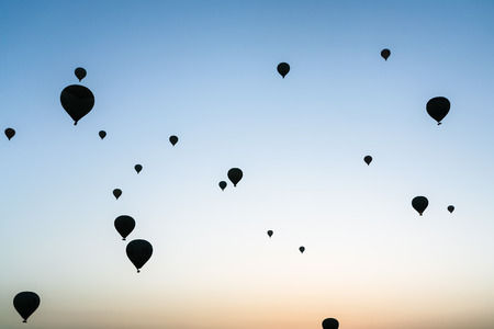 Travel to Turkey - many hot air ballons in sky at sunrise in Cappadocia in springの写真素材