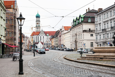 AUGSBURG, GERMANY - MAY 20, 2018: people on Maximilianstrasse and view of Basilica SS Ulrich and Afra in Augsburg town. Augsburg is a city in Swabia, Bavaria, it is third oldest city in Germanyのeditorial素材