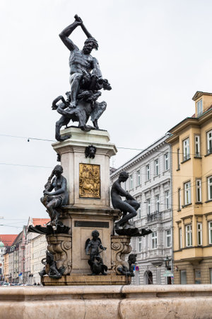 Travel to Germany - view of Herkulesbrunnen (Hercules fountain) on Maximilianstrasse street in Augsburg city in rainy spring dayのeditorial素材