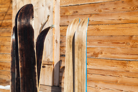 wide forest skis near wooden country house in winter in russian village in Smolensk region of Russiaの写真素材