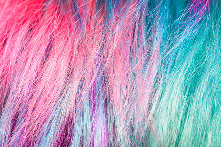 pink and green colored strands of female hairs close up