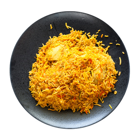 Indian cuisine - Murg Sindh Biriyani spicied chicken pulao cooked with potato in DUM style in tandoor on black plate isolated on white backgroundの写真素材