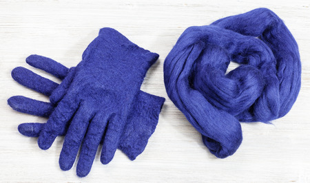 workshop of hand making a fleece gloves from blue Merino sheep wool using wet felting process - woolen felted gloves and fur material for themの写真素材