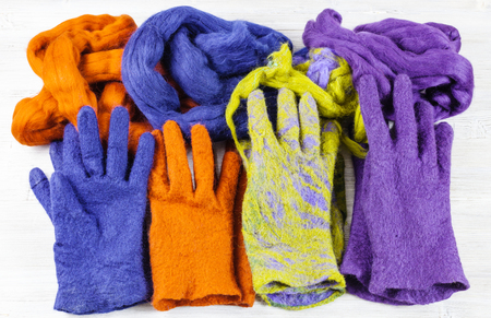 workshop of hand making a fleece gloves from sheep wool using wet felting process - multi coloured woolen handmade felted gloves and wools for themの写真素材