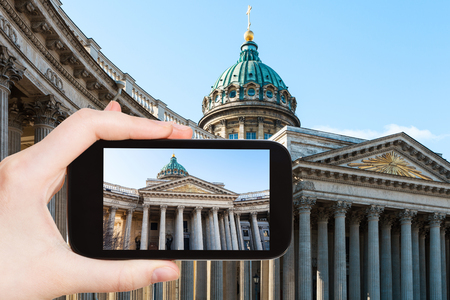 travel concept - tourist photographs of Kazan Cathedral in Saint Petersburg city in Russia on smartphoneの写真素材