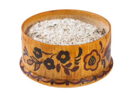 side view of wooden salt cellar with seasoned salt with spices and dried herbs isolated on white backgroundの写真素材