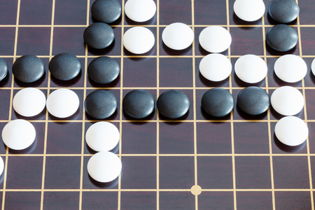 top view of playing in Go game on wooden boardの写真素材