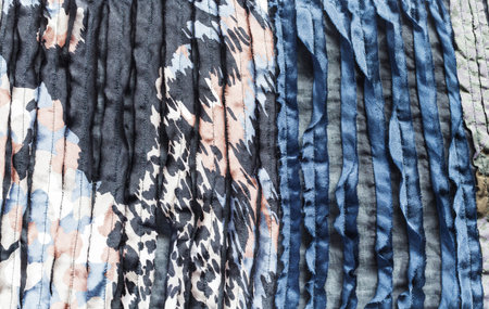 Spotted surface of scarf stitched from fabric with cuts