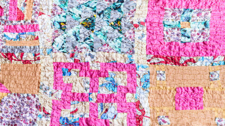 Square pattern of patchwork scarf stitched from various silk strips and crushed pink cotton fabric
