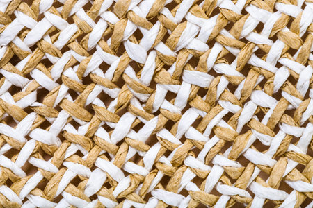 textile background - detail of summer straw hat from interwoven toyo fibers close up