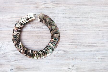 top view of nacre discs necklace on gray wooden board with copyspaceの写真素材