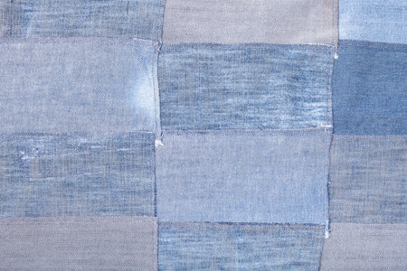textile background - patchwork from old blue denim flaps