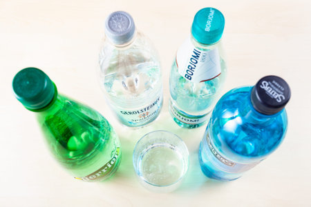 MOSCOW, RUSSIA - MAY 10, 2020: top view of various plastic bottles with naturally carbonated mineral...