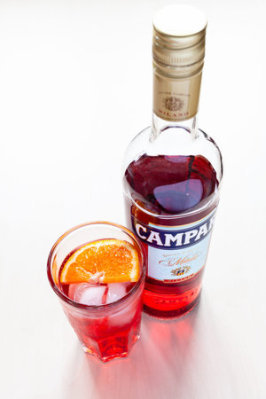 MOSCOW, RUSSIA - JUNE 4, 2020: top view of glass with cocktail and closed bottle of Campari bitter...