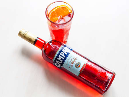 MOSCOW, RUSSIA - JUNE 4, 2020: top view of lying bottle of Campari bitter and glass with cocktail on table. Campari is italian alcoholic liqueur belong to Davide Campari Milano S.P.A. Gruppo Campariのeditorial素材
