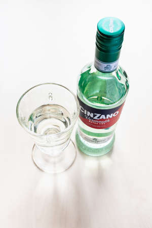 MOSCOW, RUSSIA - JUNE 4, 2020: top view of closed bottle of Cinzano Extra Dry and wineglass with drink on table. Cinzano is Italian vermouth from Turin city, now this brand belongs to Gruppo Campariのeditorial素材