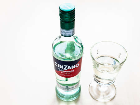 MOSCOW, RUSSIA - JUNE 4, 2020: closed bottle of Cinzano Extra Dry and glass with drink on table. Cinzano is Italian vermouth from Turin city, now this brand belongs to Gruppo Campariのeditorial素材