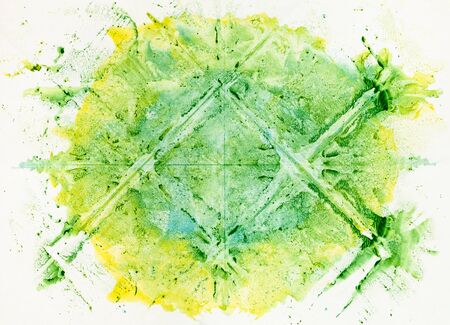 Abstract symmetric monotyping painting handcrafted with green and yellow watercolors on old paperの写真素材