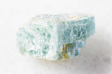 closeup of sample of natural mineral from geological collection - unpolished Apatite rock on white marble backgroundの写真素材