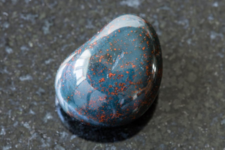 macro photography of sample of natural mineral from geological collection - tumbled Heliotrope...